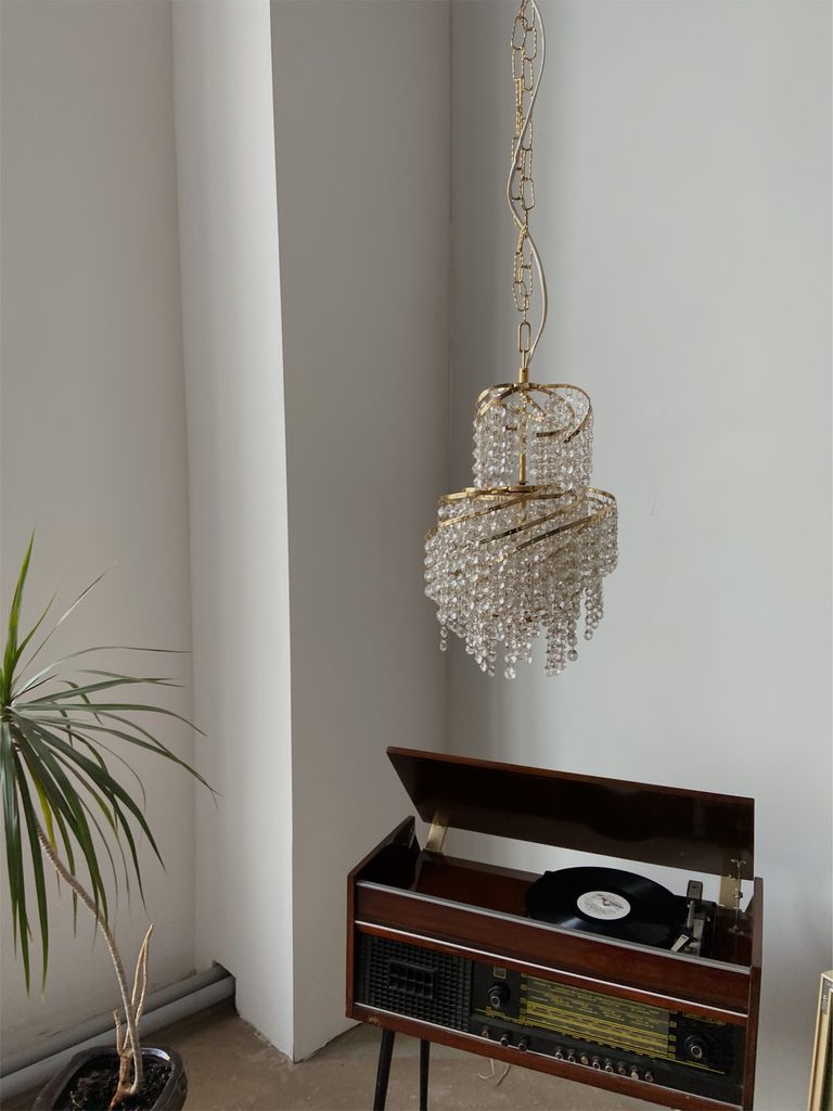 Small crystal chandelier hanging in a home interior