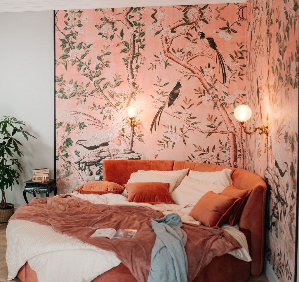 Black Nouveau aesthetic bedroom with warm botanical wallpaper and layered bedding